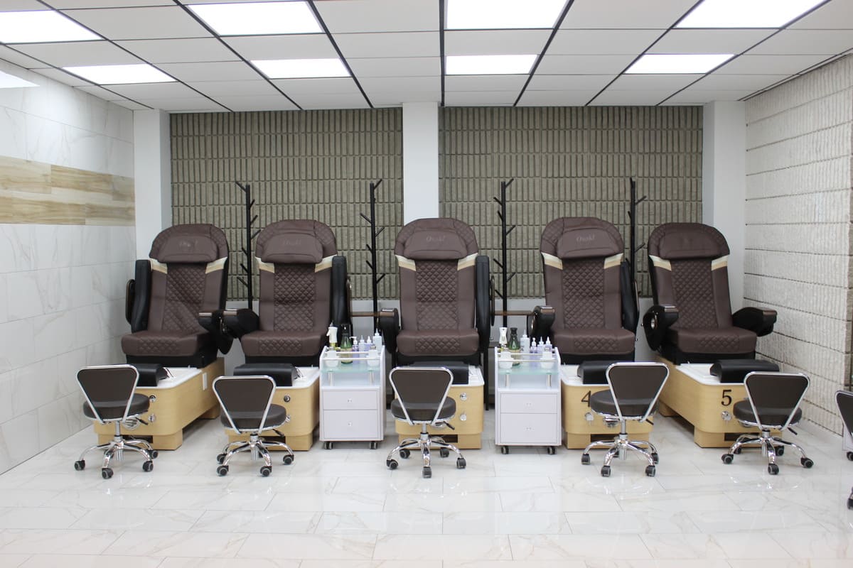 a row of pedicure chairs sitting in a room next to each other